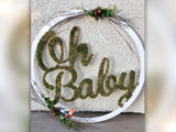 Woodland theme decorate Oh baby cutout sign placed on floor leaning against wall