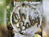 Oh baby sign decorated with twigs and moss glued to the interior of the words Oh baby